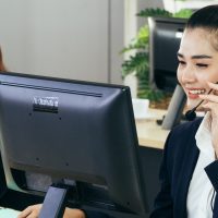 asian-young-beautiful-woman-staff-at-service-desk-talking-on-phone-in-a-call-centre-with-her_t20_eVXbKK